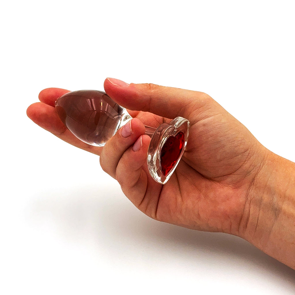 Photo of Red Heart Gem Glass Anal Plug held in hand to demonstrate size.